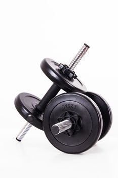Black gym barbell, dumbbell with disks, isolated on white background.
