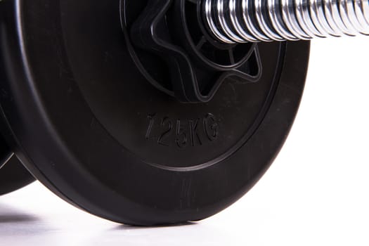 Close up view of single black gym barbell, dumbbell, isolated on white background.