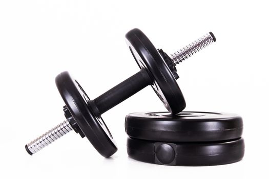 Black gym barbell, dumbbell with disks, isolated on white background.