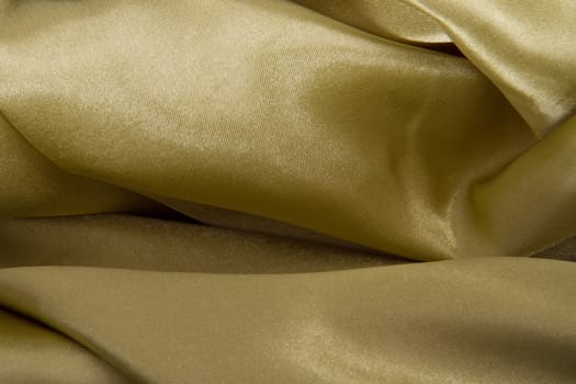 Abstract yellow background fabric,cloth, silk texture satin or velvet material.