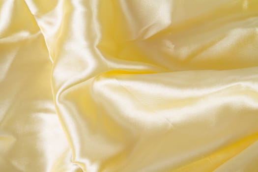 Abstract yellow background fabric,cloth, silk texture satin or velvet material.