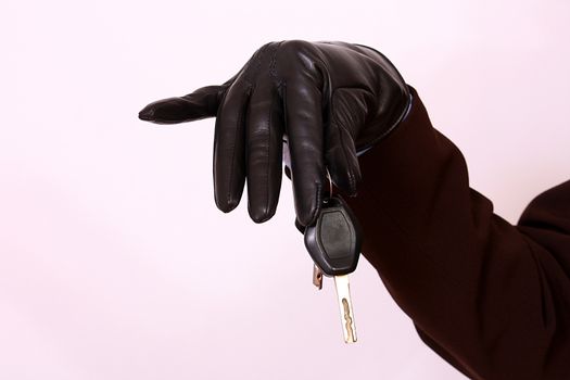 close up of gloved hand holding car keys