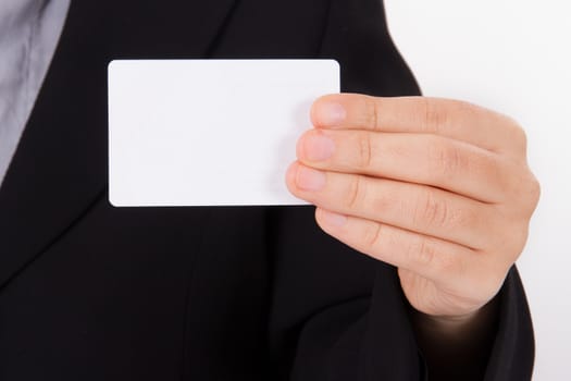 Business woman in dark suit shows white blank business card with space.