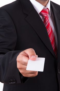Businessman in dark suit and white shirt with red striped tie, shows white blank business card with space.