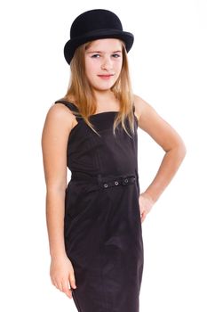Beautiful girl wearing black dress and bowler hat in studio. Isolated on white backround.