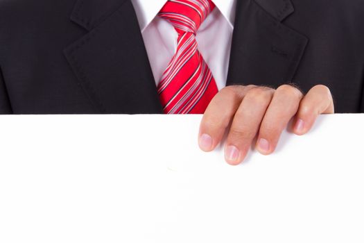 Businessman with red striped tie and dark jacket holding blank board.
