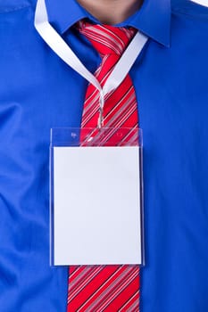 Businessman with red tie and blue shirt using blank, empty, white name tag