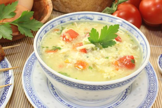 Asian Chicken soup with eggs, noodles and greens