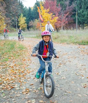 Cute little boy on bicycle in the autumn park.