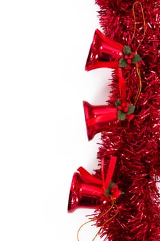 Red xmas ornaments with bells as border, isolated on white background.