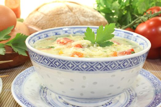 Asian Chicken soup with eggs and noodles on bright background