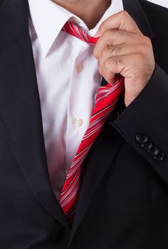 Bored businessman holding red tie.