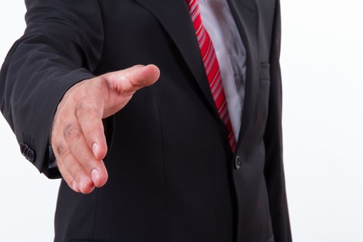 Businessman extends hand to shake or helping, isolated on white.