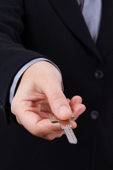Young business woman extends home key.