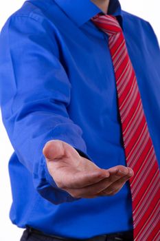 Businessman with blue shirt extends his hand and want something.