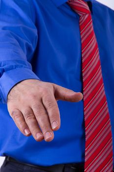 Businessman with blue shirt showing hand for handshake or help.