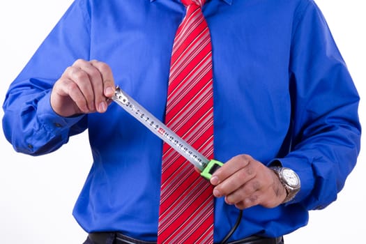 Businessman with red tie and blue shirt holding tape measure, isolated on white background.
