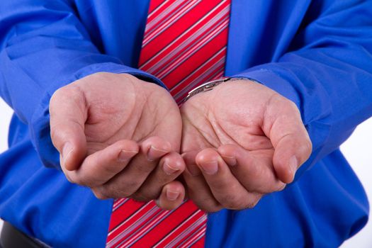 Businessman with blue shirt shows hands.