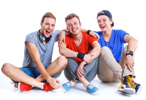 Portrait of three young happy smiling teenagers. Isolated on white background.