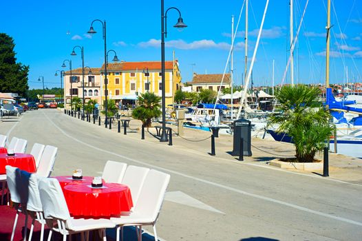 Sunny day in Novigrad harbor, view on a bay and hotels from a cafe