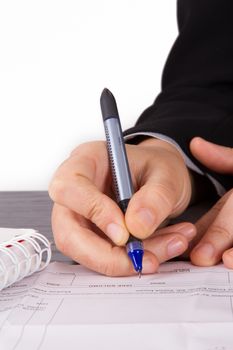Business woman signing contract on table.