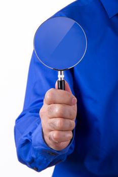 Businessman with blue shirt holding and showing magnifying glass , isolated on white background.