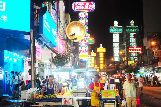 Bangkok, Thailand - March 03, 2013: People at Yaowarat Road in the evening in Bangkok. Yaowarat Road is a main street in Bangkok's Chinatown, it was opened in 1891 in the reign of King Rama V.