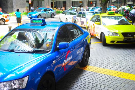 Singapore, Republic of Singapore -  March 08, 2013 : Taxi cabs on the road in Singapore. The government will spend SGP$14 billion to improve Singapore's road infrastructure 