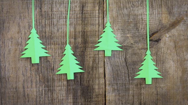 Christmas tree decoration on wood textured background.