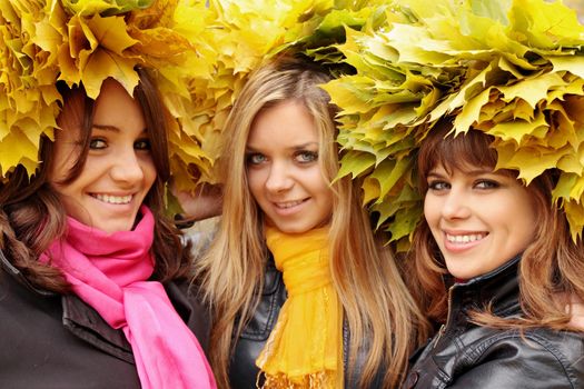 happy womans wearing a wreath of yellow leaves