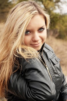 Portrait of a beautiful young woman in autumn park