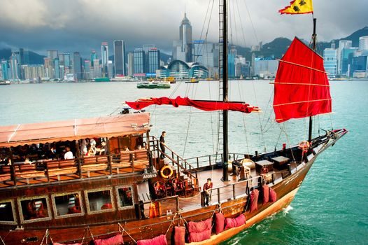 Hong Kong - May18, 2013: Traditional chinese-style tourist junk sailing in Hong Kong harbor . Overall visitor arrivals to Hong Kong in 2012 totalled just over 38 million, a 24% increase over the previous year.