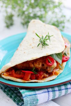 pita bread stuffed with meat, sauce and chili