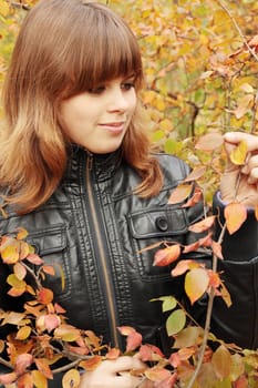 Portrait of a beautiful young woman in autumn park