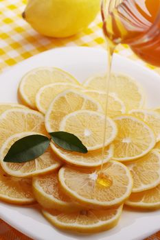 pour honey lemon slices on a plate