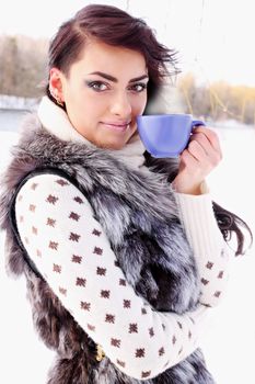 Young woman with a cup of hot drink