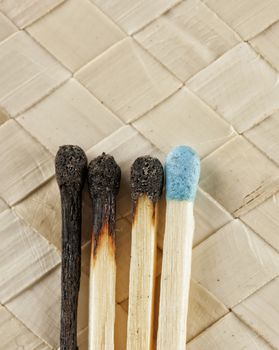 Close up of four matches, three burned