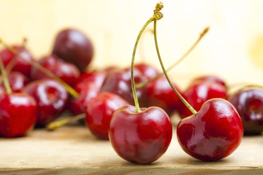fresh red cherries on a wooden table