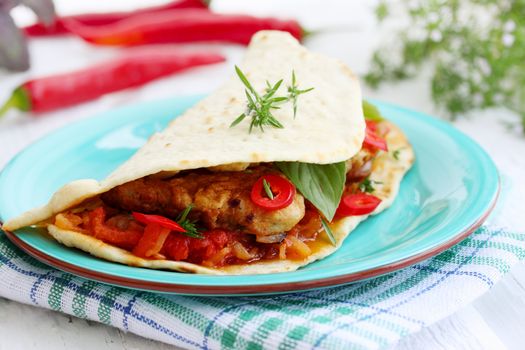 pita bread stuffed with meat, sauce and chili
