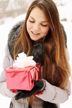 young girl holding a gift in their hands