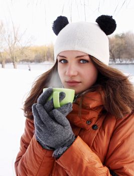 Young woman with a cup of hot drink