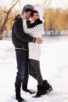 Young beautiful couple on nature in winter