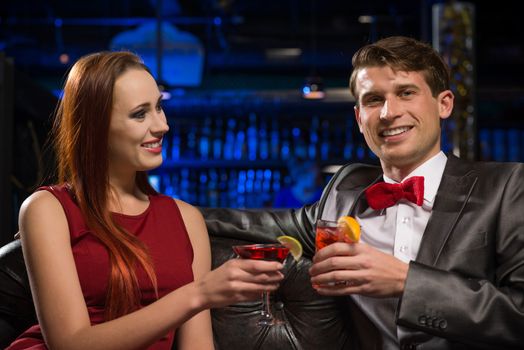 Young couple talking in a nightclub, have fun