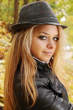 Portrait of a beautiful young woman in autumn park