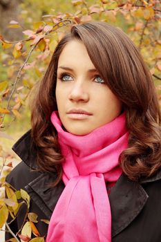 Portrait of a beautiful young woman in autumn park