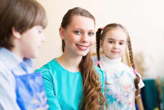 children draw with the teacher in the classroom drawing