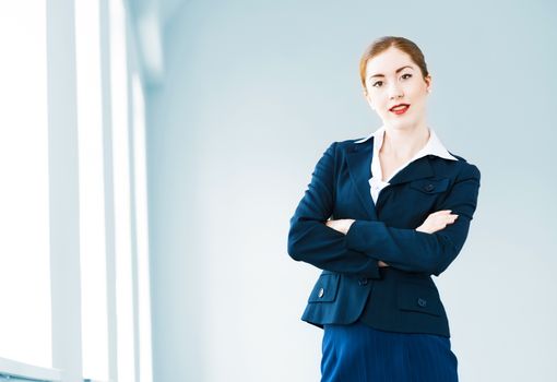 young modern business woman, crossed her arms and smiles