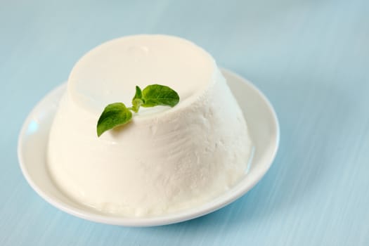 dessert of ricotta cheese with leaf oregano