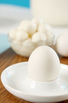 Egg with milk products, still life in white