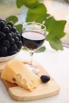 still life with  wine glass, cheese and grapes